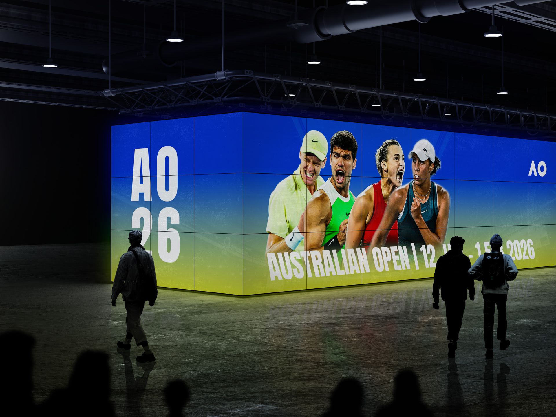 Australian Open 2026 — large indoor LED wall installation across a full corner wall in a dark venue space, showing the AO key visual and the text AO 26 on the left panel